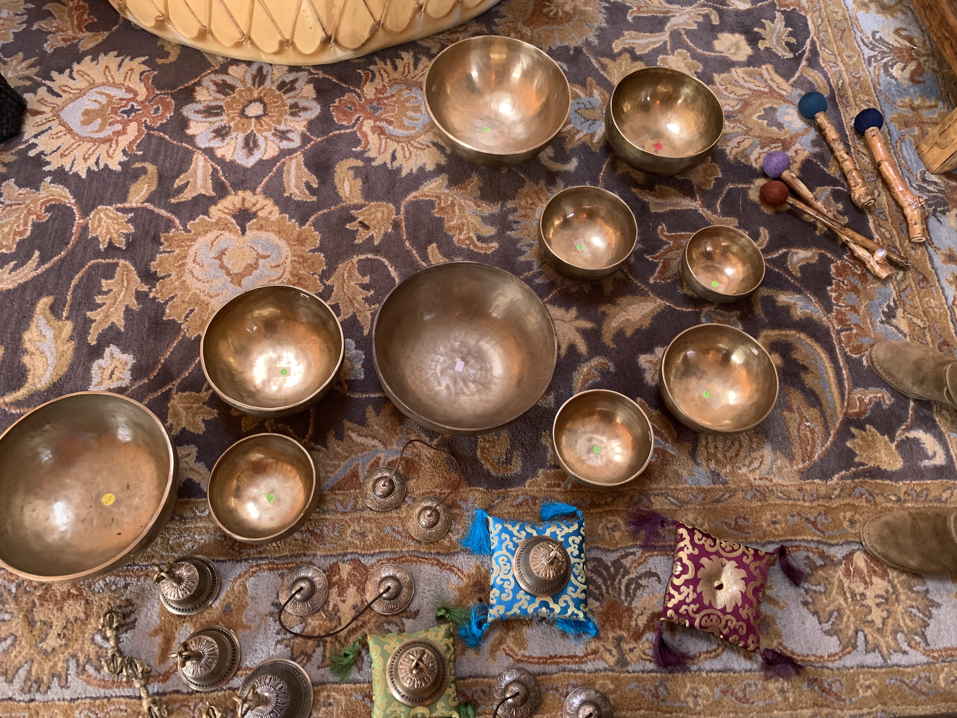 Tibetan Bowls of multiple sizes on a rug